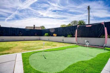 Backyard golf practice area landscaping