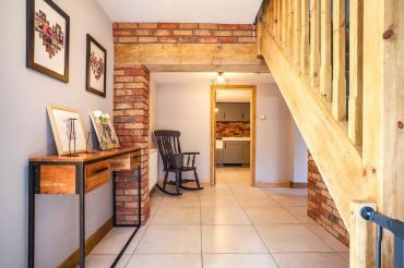 Hallway with brick walls and staircase